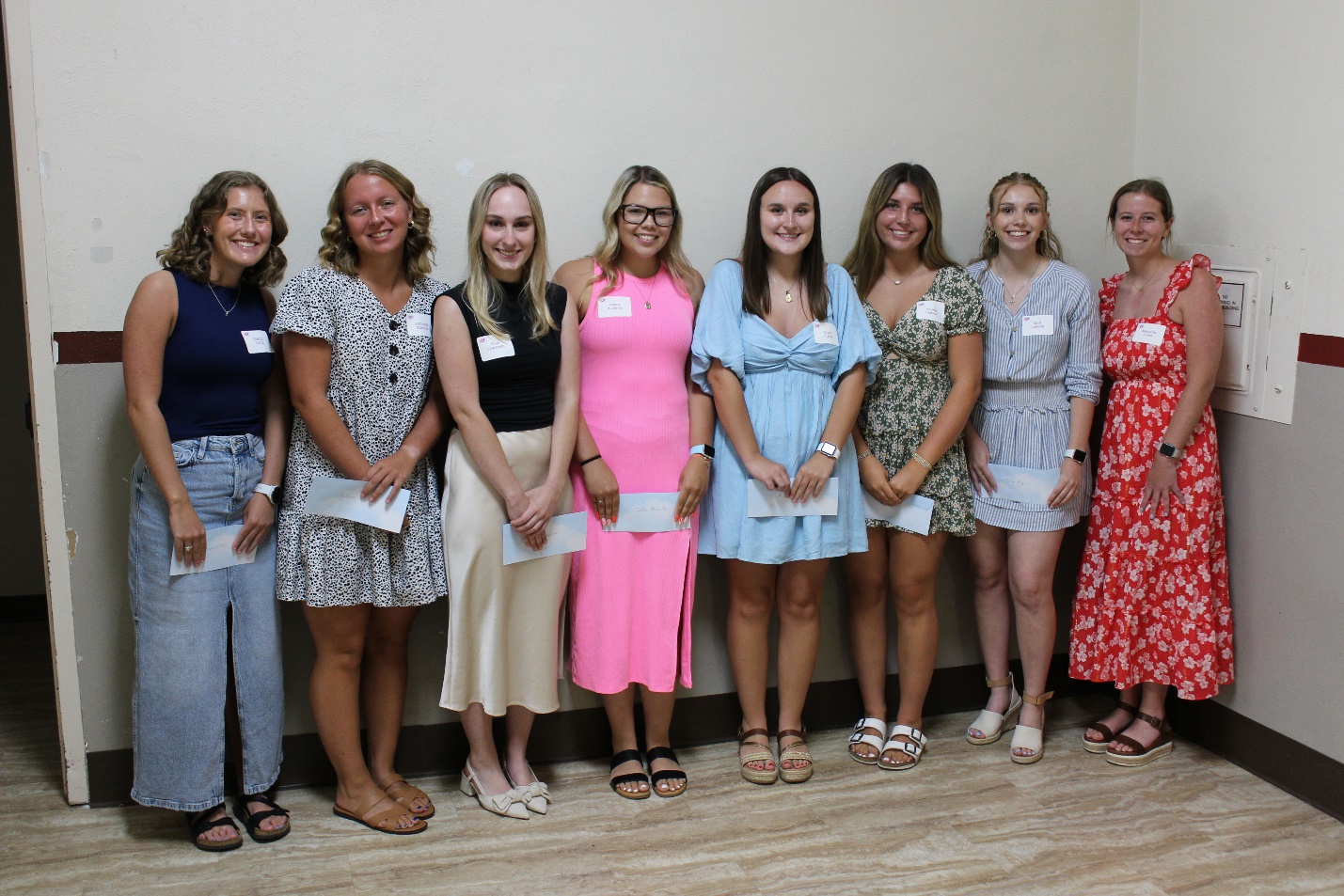 A group of women posing for a photo
Description automatically generated